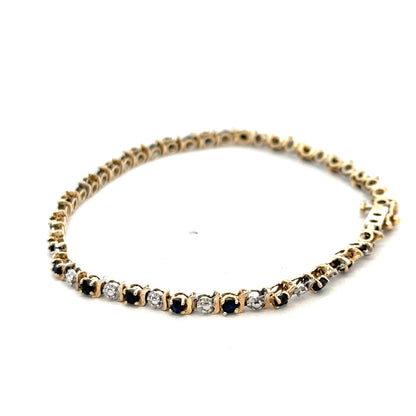 9ct yellow gold sapphire and diamond bracelet with intricate design, weighing 4.8g, crafted by Reeves and Sons.