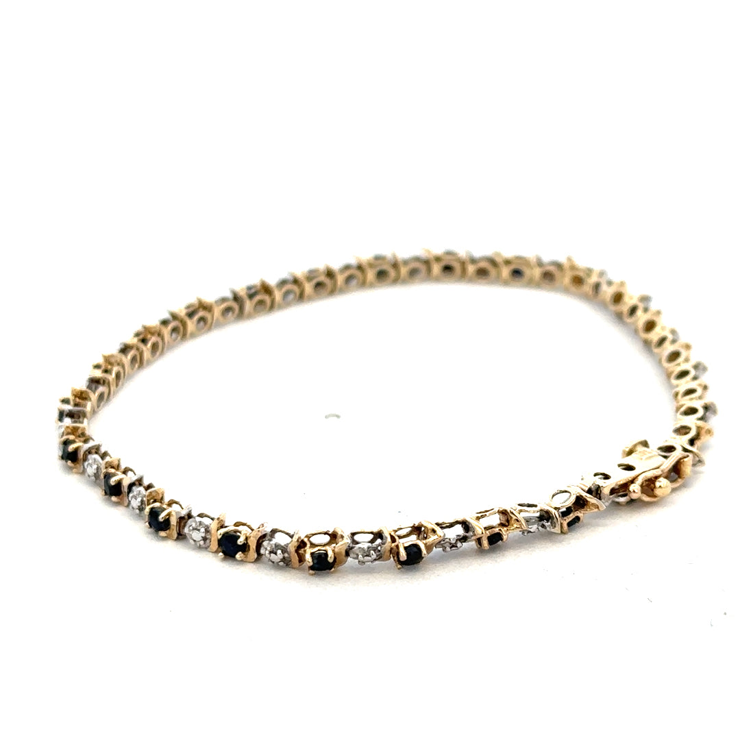 9ct yellow gold sapphire and diamond bracelet with intricate design, weighing 4.8g, crafted by Reeves and Sons.