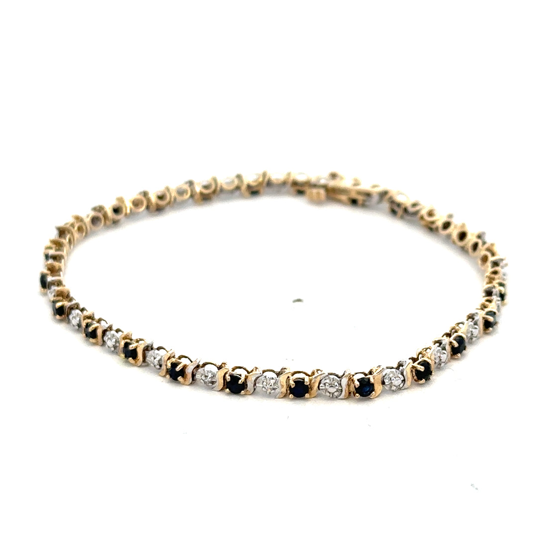 9ct yellow gold sapphire and diamond bracelet with intricate design, weighing 4.8g, from Reeves and Sons.