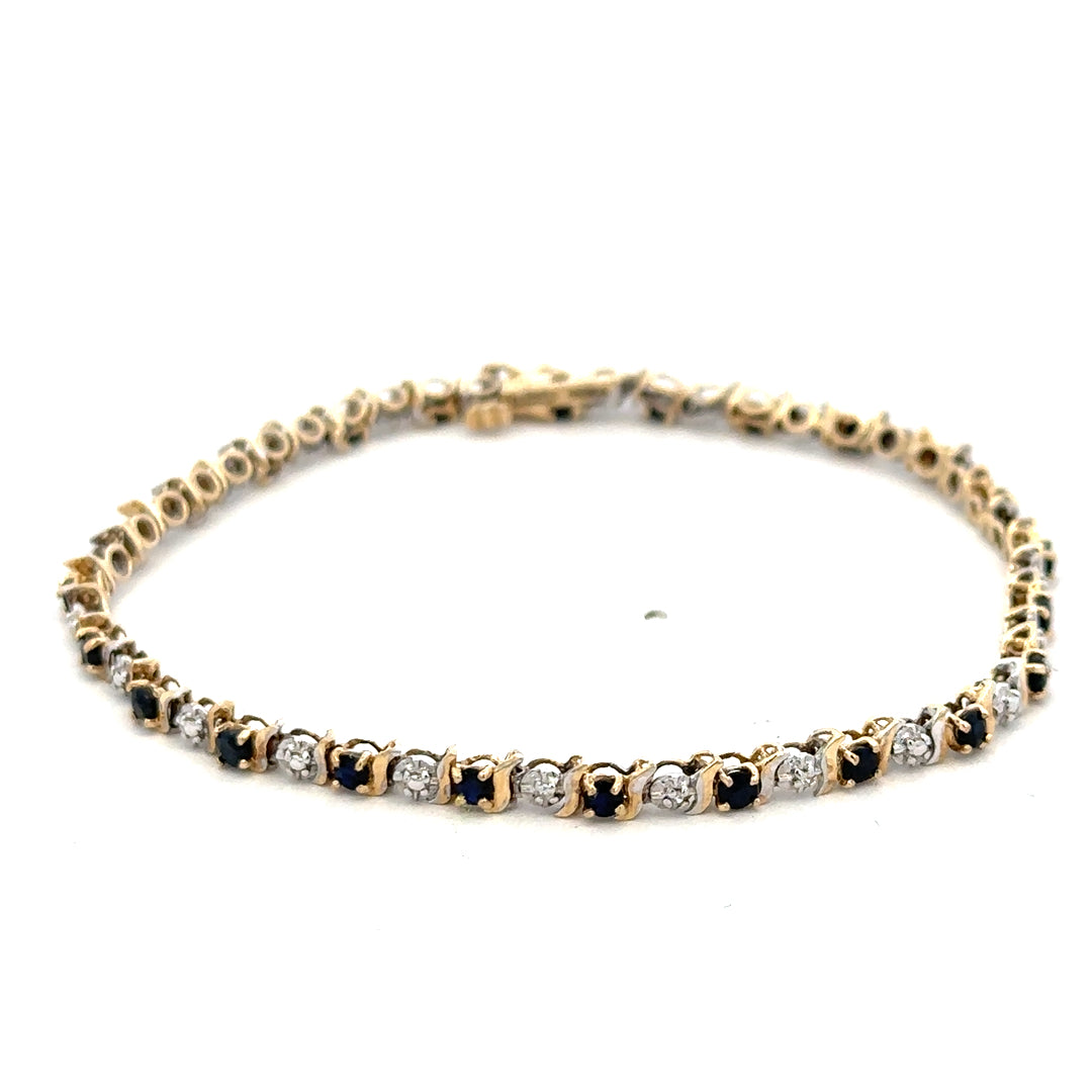 9ct yellow gold sapphire and diamond bracelet with intricate design, weighing 4.8g, from Reeves and Sons.