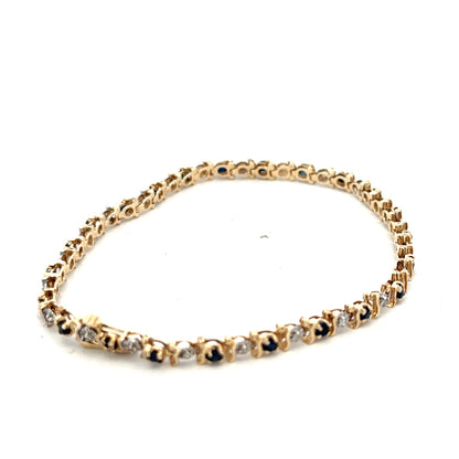 9ct yellow gold sapphire and diamond bracelet with intricate design, weighing 6.5g, crafted by Reeves and Sons.