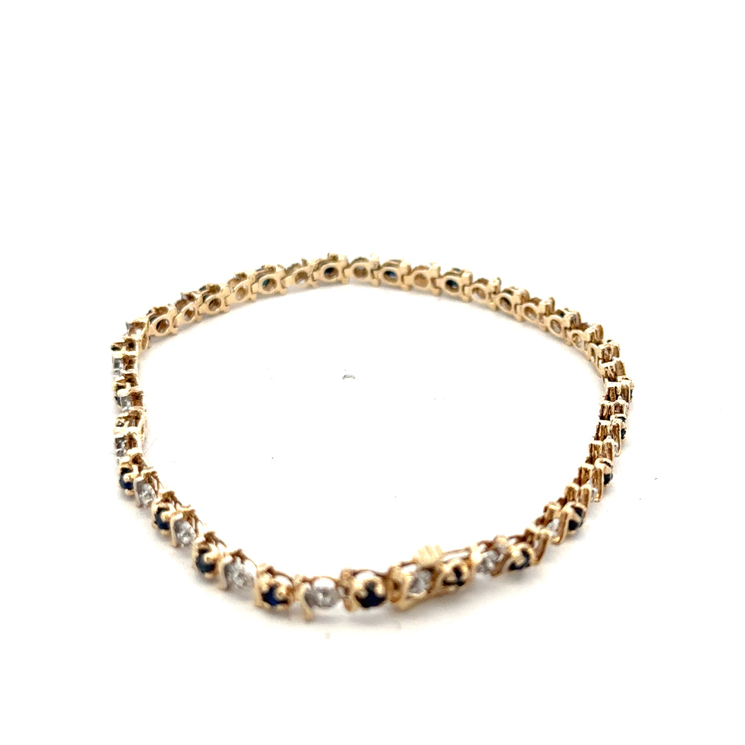 9ct yellow gold sapphire and diamond bracelet with intricate design, weighs 6.5g, crafted by Reeves and Sons.
