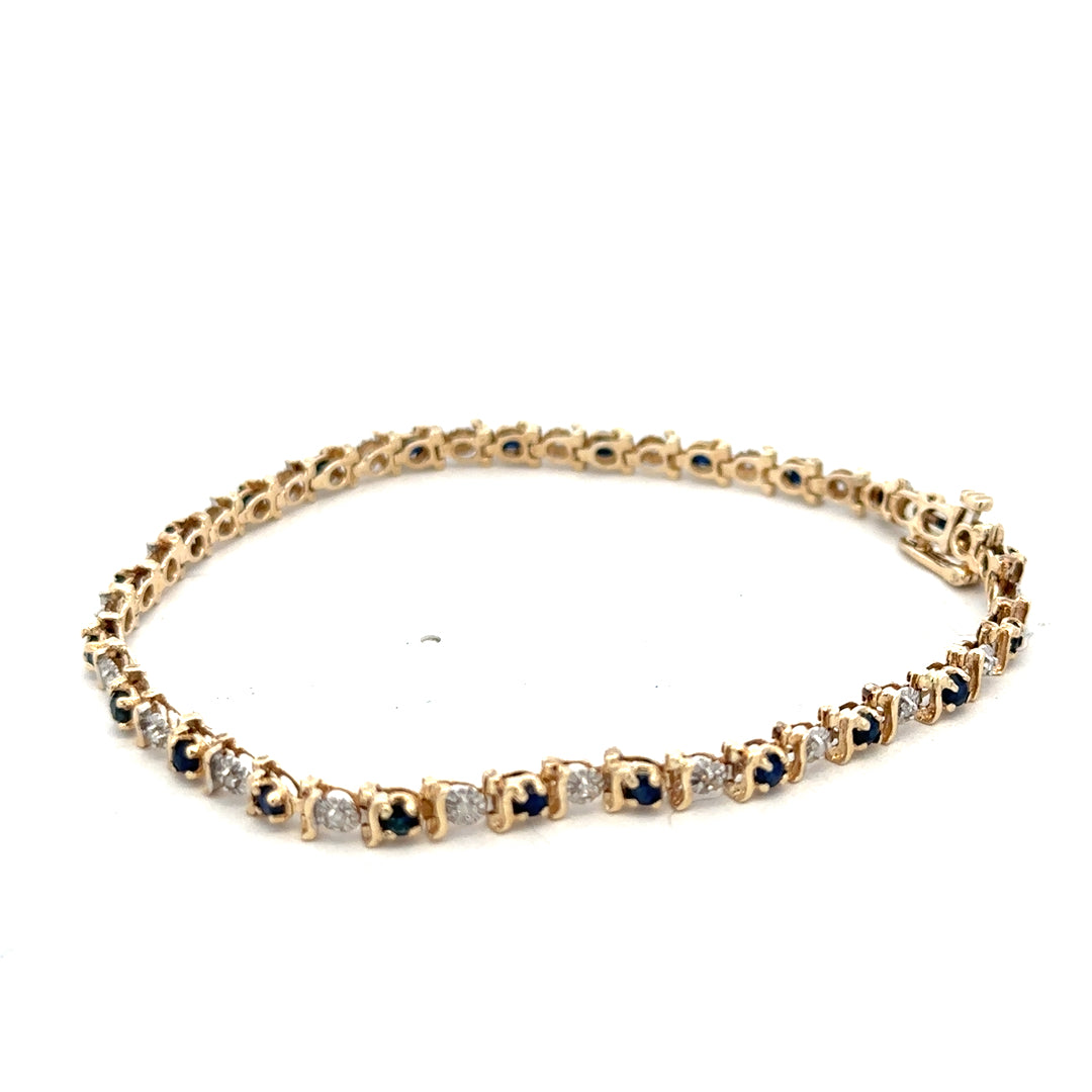 9ct yellow gold sapphire and diamond bracelet with intricate design, weighing 6.5g, from Reeves and Sons.