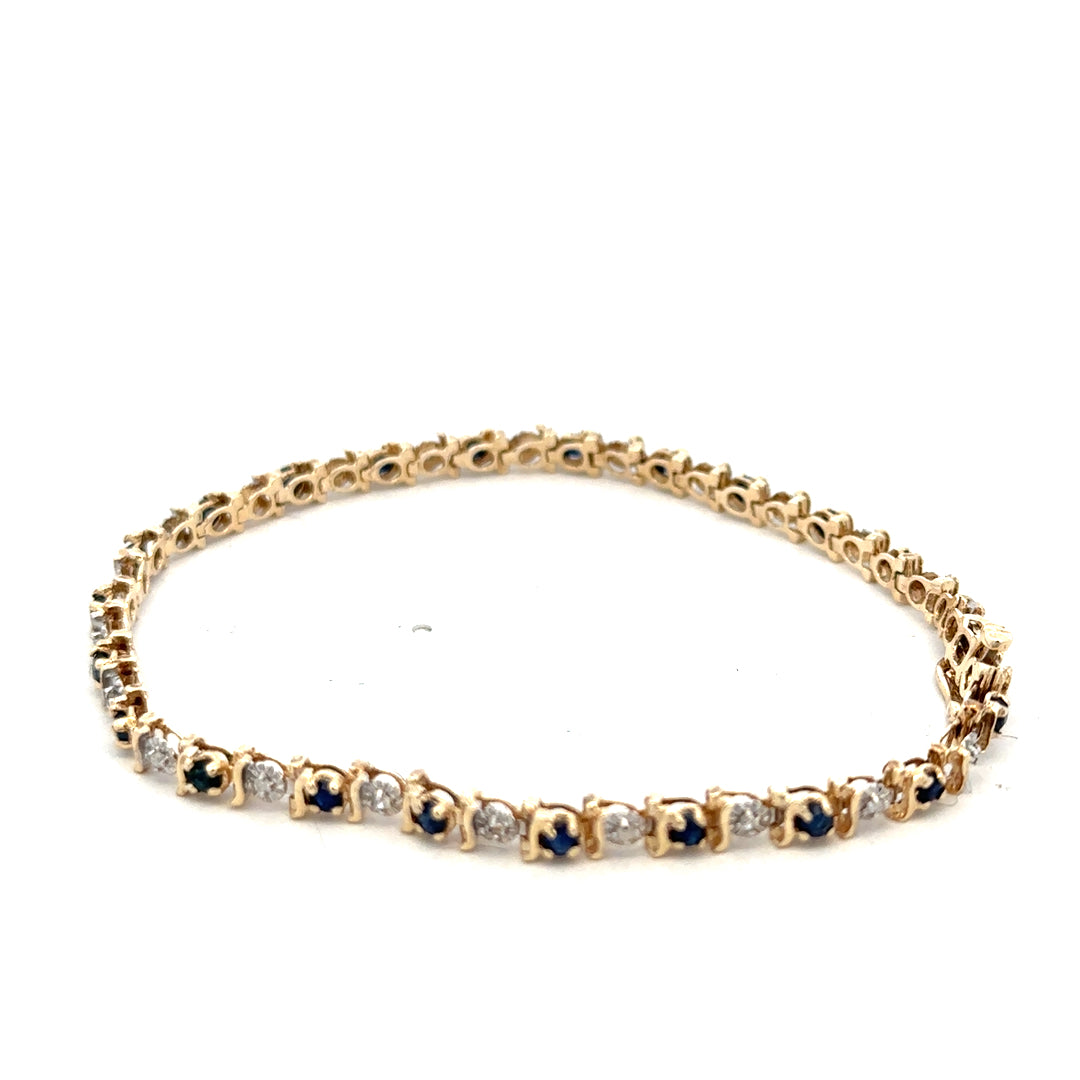 9ct yellow gold sapphire and diamond bracelet with intricate design, showcasing sparkling gemstones and fine craftsmanship.
