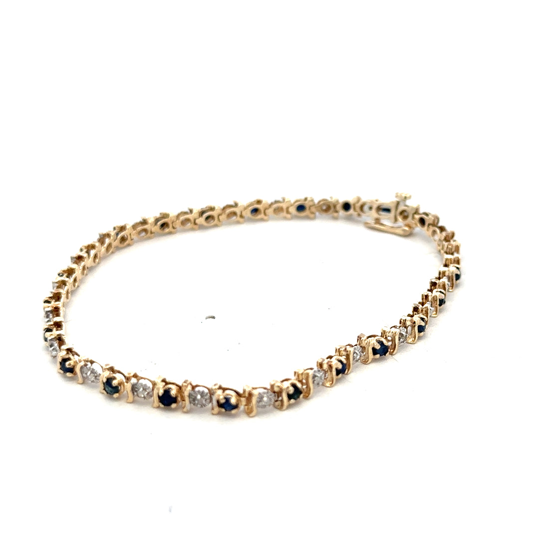 9ct yellow gold sapphire and diamond bracelet with intricate design, weighing 6.5g, by Reeves and Sons.