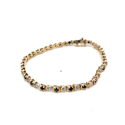 9ct yellow gold sapphire and diamond bracelet by Reeves and Sons, showcasing a elegant design with sparkling gemstones.