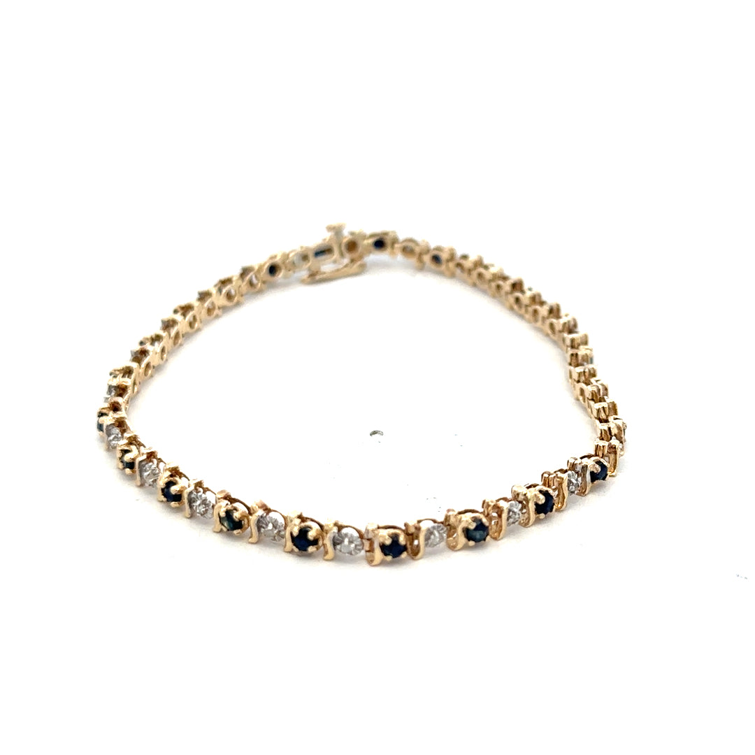 9ct yellow gold sapphire and diamond bracelet featuring sparkling stones and intricate design, weighing 6.5g.