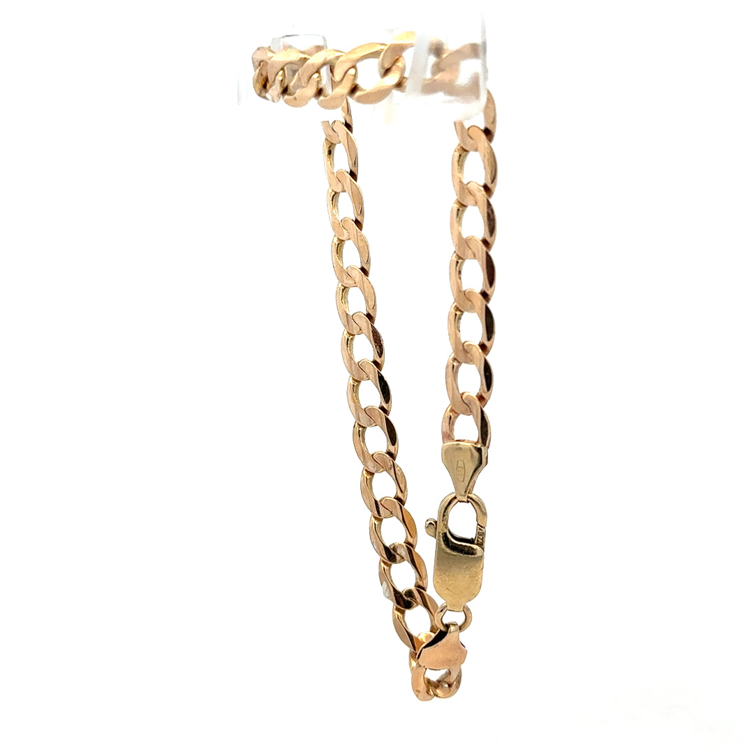 9ct yellow gold curb bracelet with a polished finish, weighing 10.6g, from Reeves and Sons.