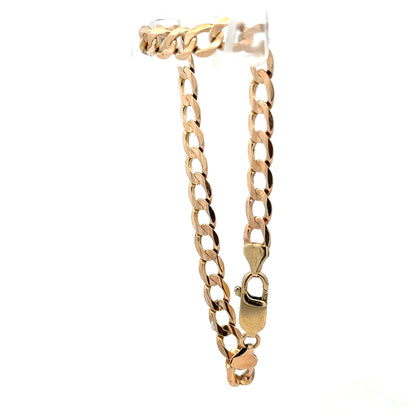 9ct yellow gold curb bracelet with a polished finish, weighing 10.6g, from Reeves and Sons.