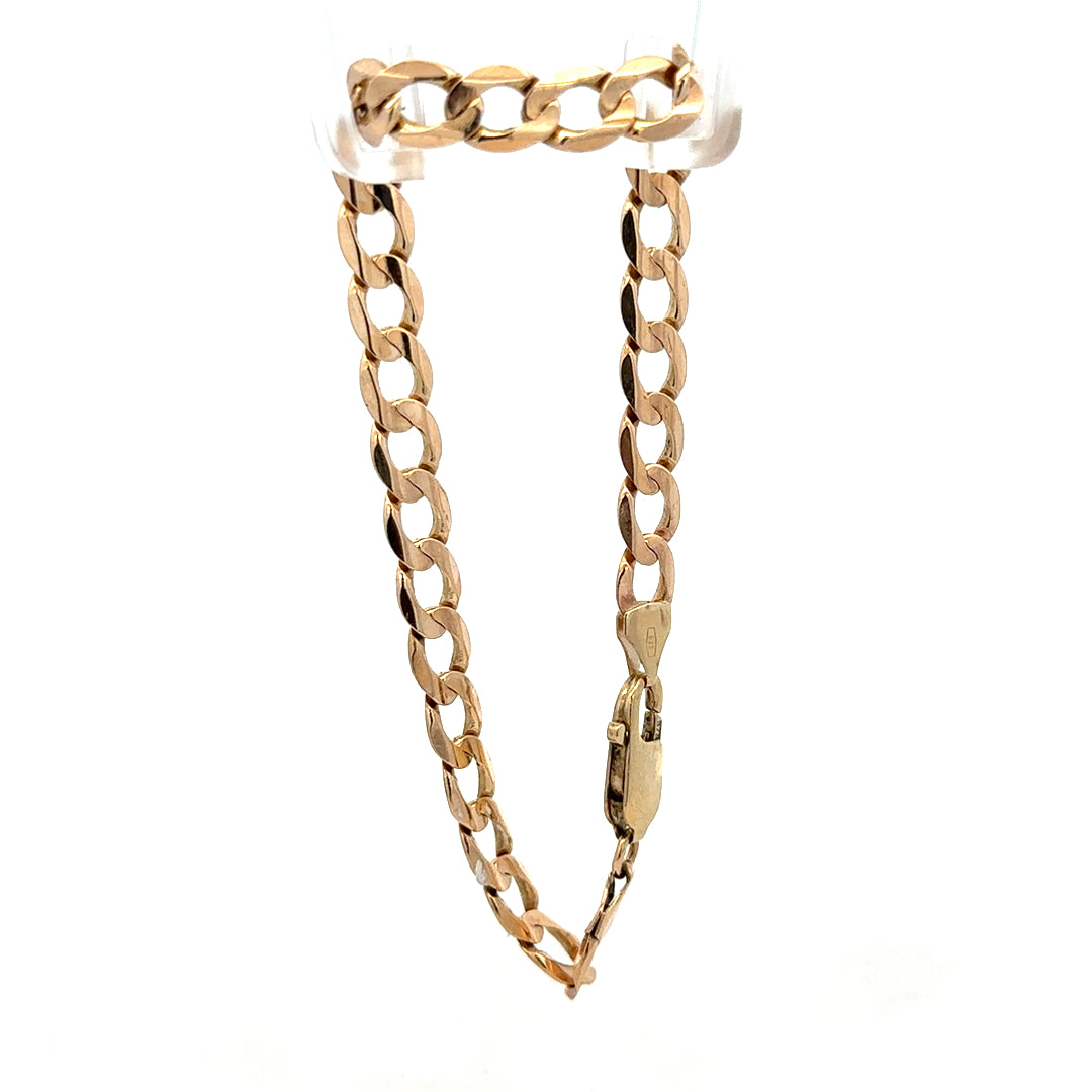 9ct yellow gold curb bracelet weighing 10.6g with a polished finish, featuring closely linked oval chains, by Reeves and Sons.