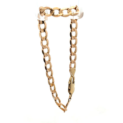 9ct yellow gold curb bracelet weighing 10.6g with a polished finish, featuring closely linked oval chains, by Reeves and Sons.