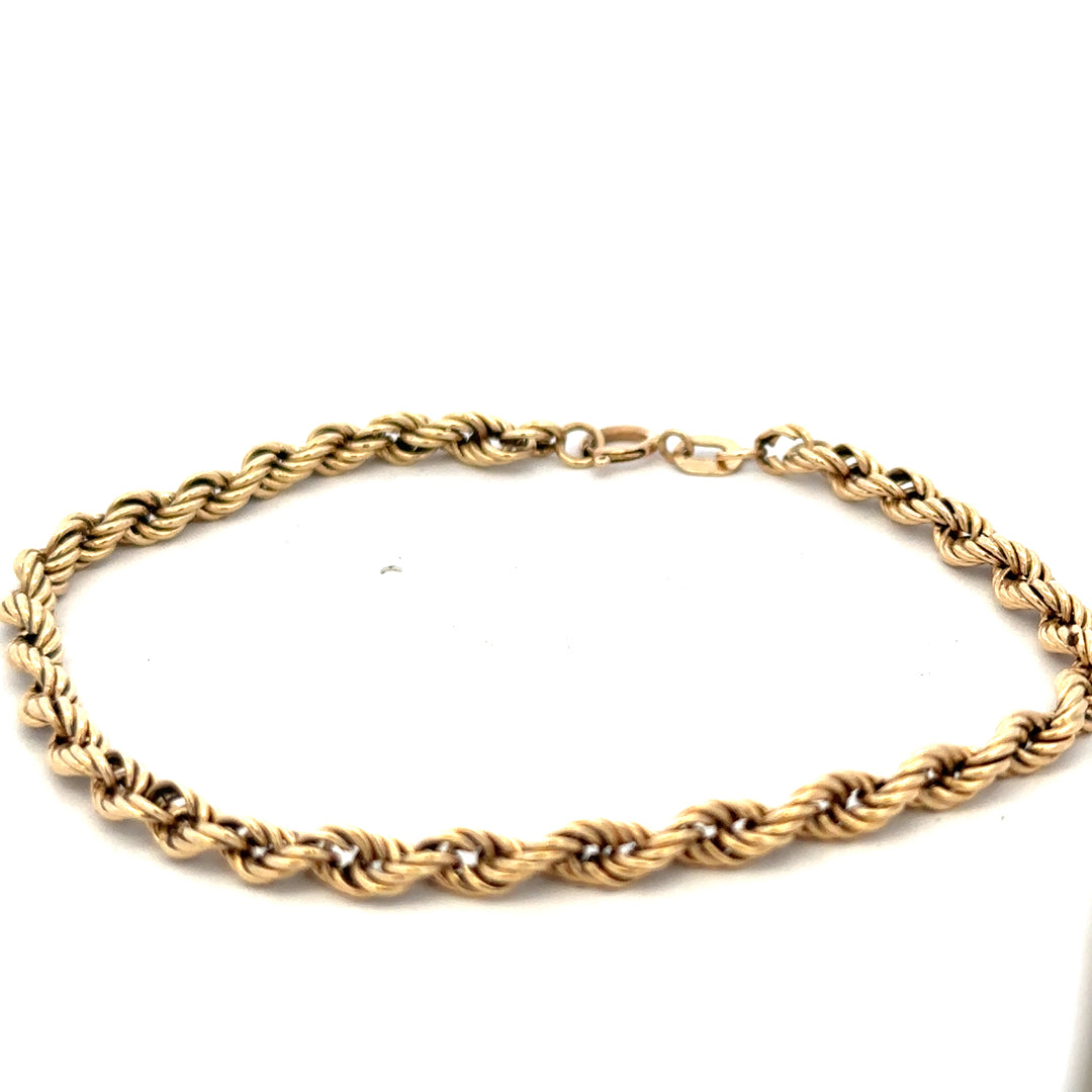 9ct yellow gold rope bracelet with a textured design, weighing 2.8g, from Reeves and Sons.