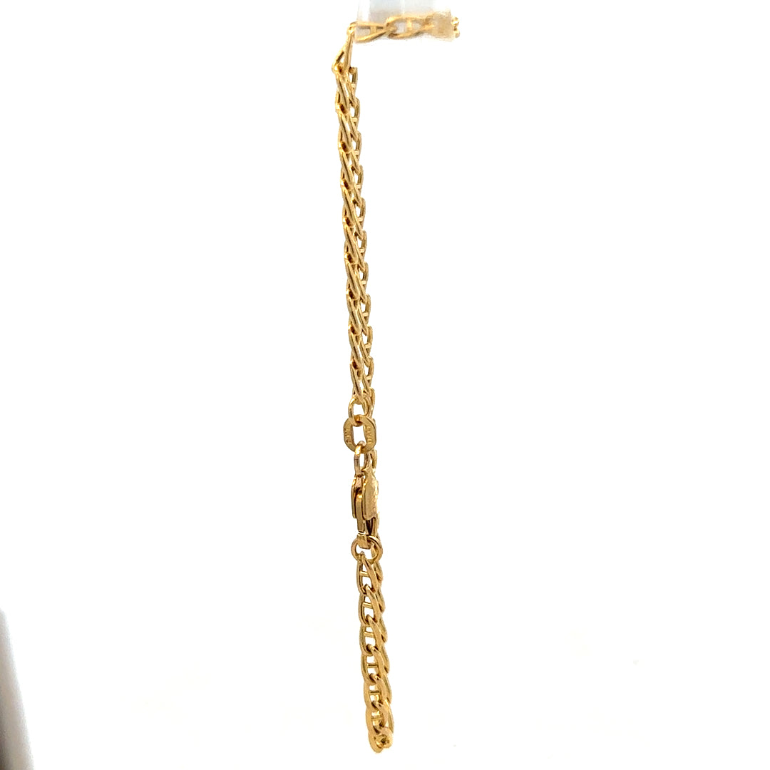 9ct yellow gold bracelet weighing 2.2g with delicate chain and clasp, crafted by Reeves and Sons, displayed on a neutral background.