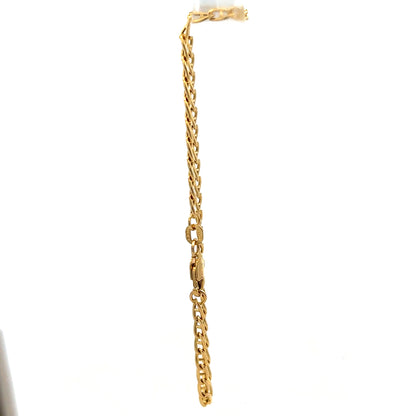 9ct yellow gold bracelet weighing 2.2g with delicate chain and clasp, crafted by Reeves and Sons, displayed on a neutral background.