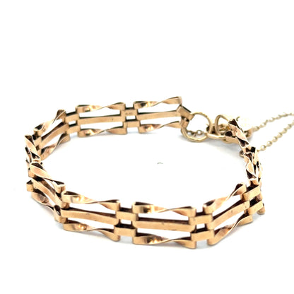 9ct yellow gold gate bracelet weighing 8.4g with a secure clasp, featuring polished rectangular links, by Reeves and Sons.
