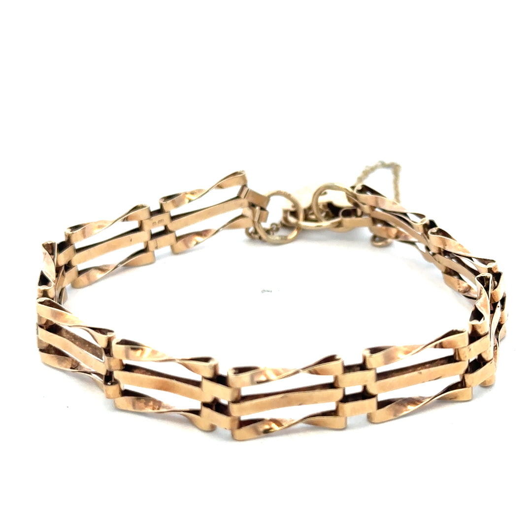 9ct yellow gold gate bracelet weighing 8.4g with link details, crafted by Reeves and Sons, displayed on a neutral background.