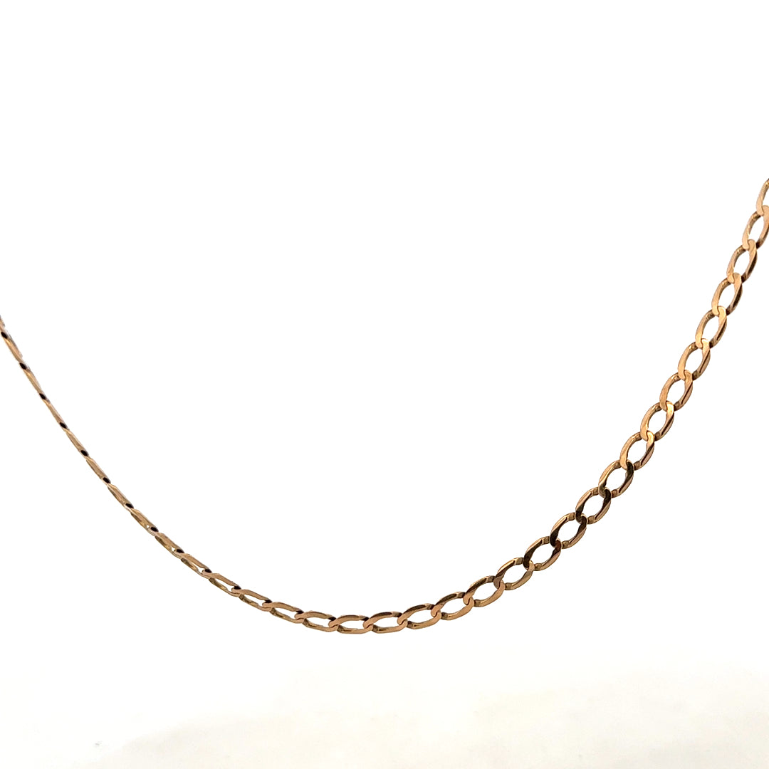 9ct yellow gold curb chain weighing 7.6g, with a detailed close-up showing its links and shine.