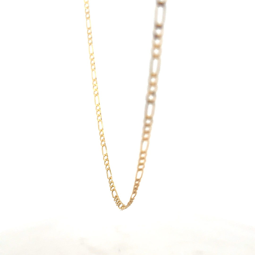 9ct yellow gold Figaro chain weighing 3.3g with intricate links, crafted by Reeves and Sons, shown in close-up detail.