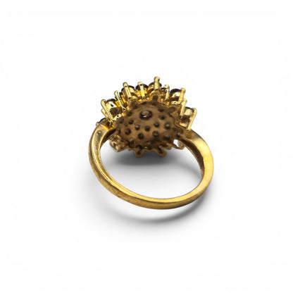 9ct yellow gold diamond cluster ring by Reeves and Sons, featuring a sparkling diamond cluster design on a polished gold band.