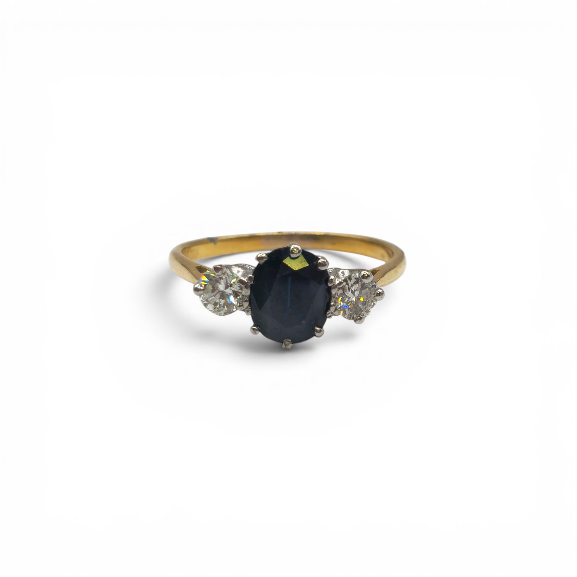 9ct yellow gold sapphire and diamond ring by Reeves and Sons, featuring a central sapphire gemstone with diamond accents.