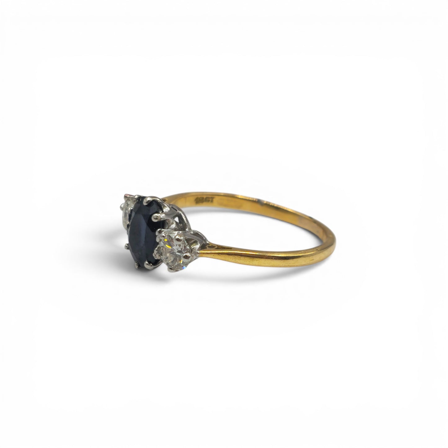9ct yellow gold sapphire and diamond ring by Reeves and Sons featuring a vibrant sapphire center stone and sparkling diamonds.