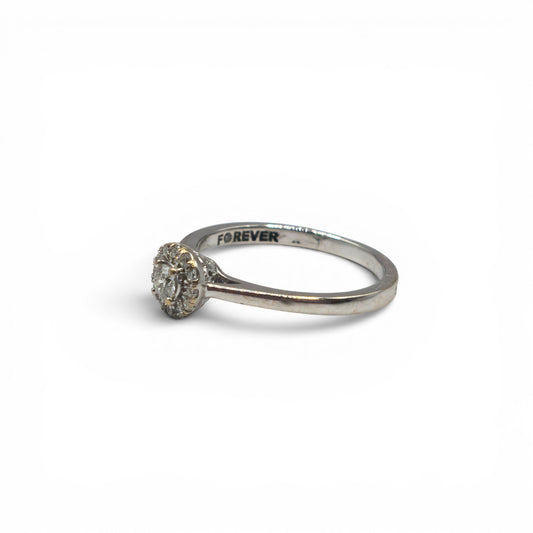 18ct white gold diamond ring by Reeves and Sons, showcasing a sparkling diamond design on a polished band.