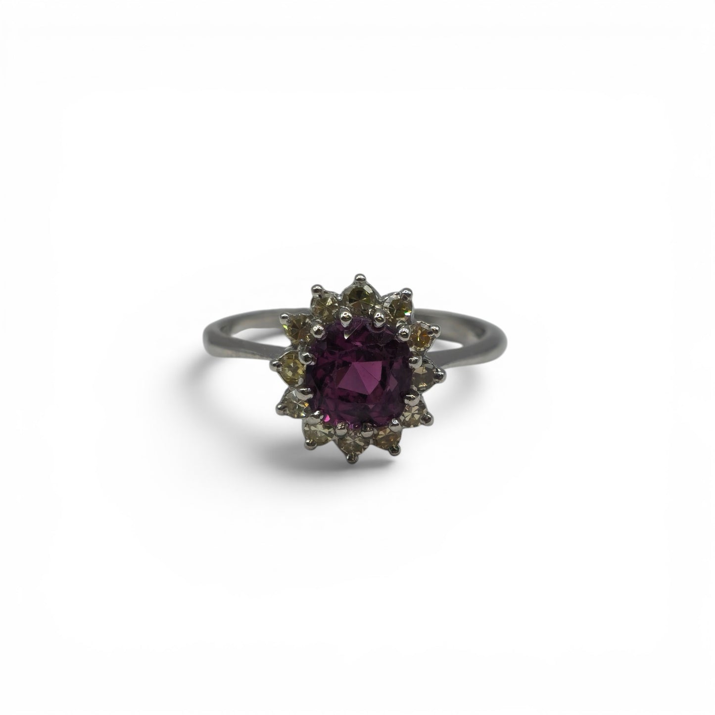18ct white gold garnet and diamond ring by Reeves and Sons, featuring a central garnet gemstone surrounded by diamonds.