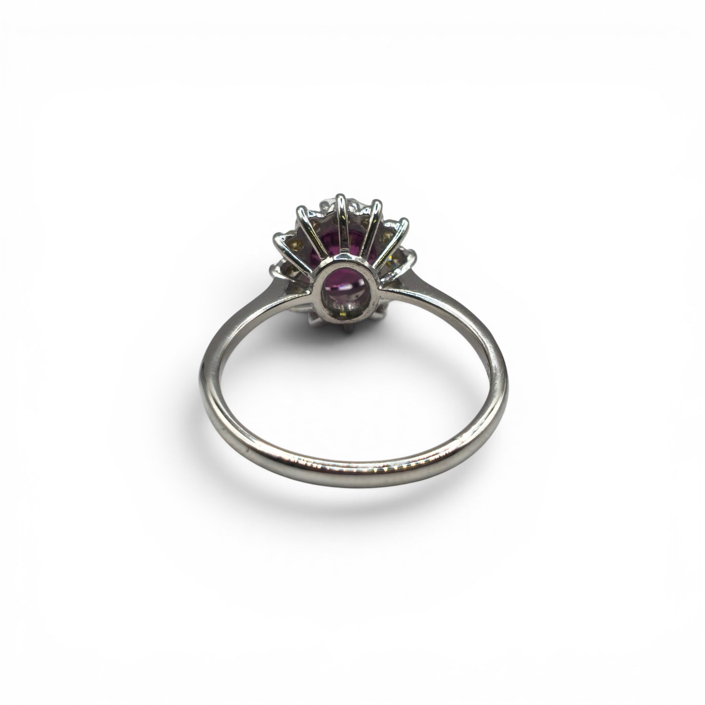 18ct white gold garnet and diamond ring by Reeves and Sons, featuring a central garnet gemstone and sparkling diamonds.