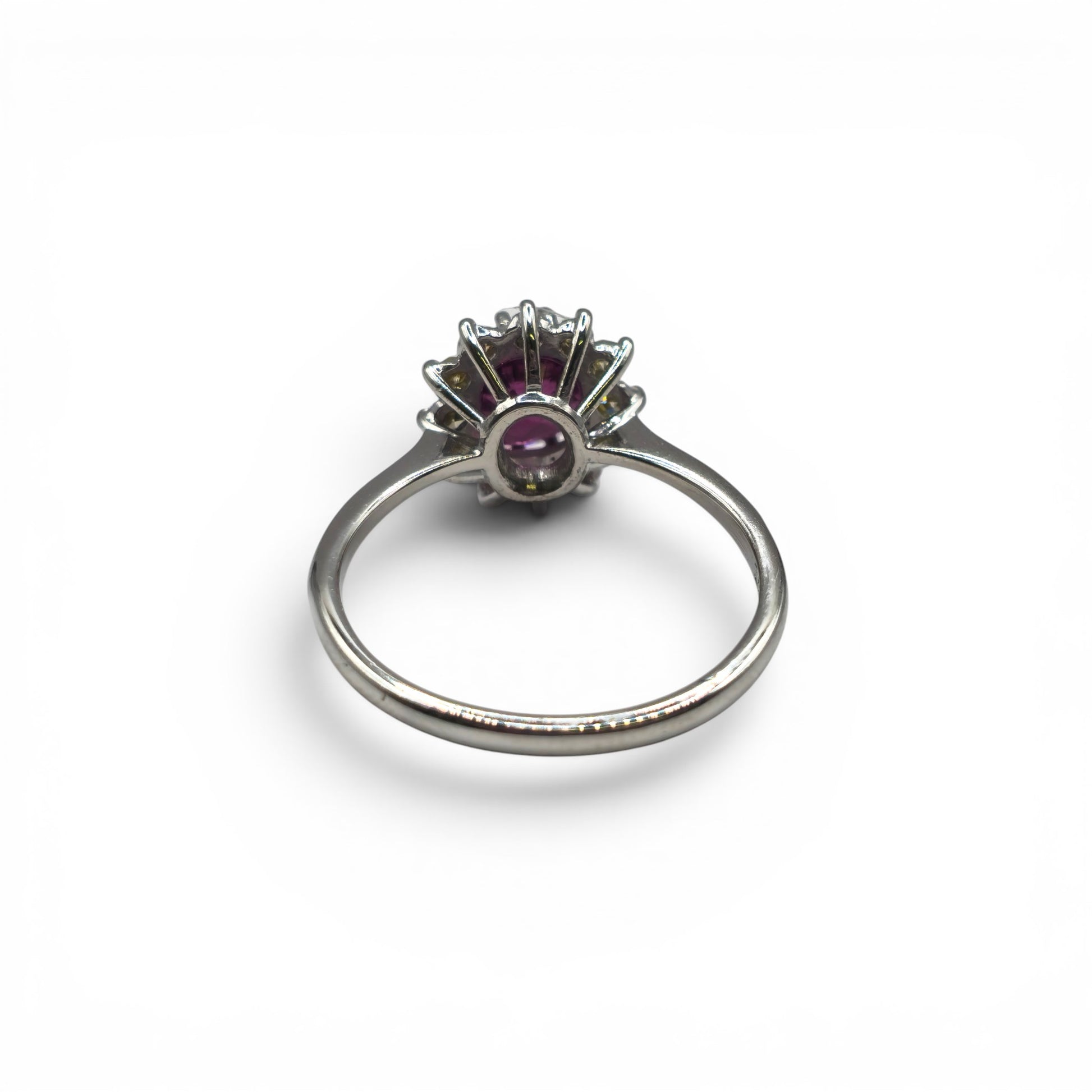18ct white gold garnet and diamond ring by Reeves and Sons, featuring a central garnet gemstone and sparkling diamonds.