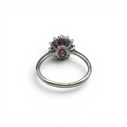 18ct white gold garnet and diamond ring by Reeves and Sons, featuring a central garnet gemstone and sparkling diamonds.