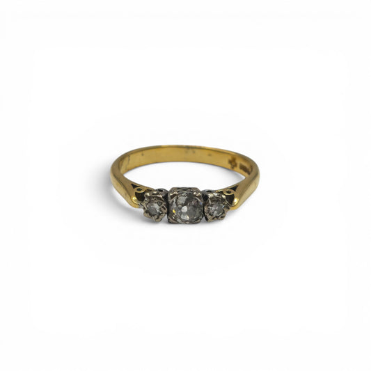 18ct yellow gold diamond ring by Reeves and Sons with sparkling diamonds and a polished band, displayed on a neutral background.