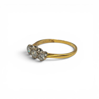 18ct yellow gold three-stone diamond ring by Reeves and Sons, showcasing sparkling diamonds set in a classic design.