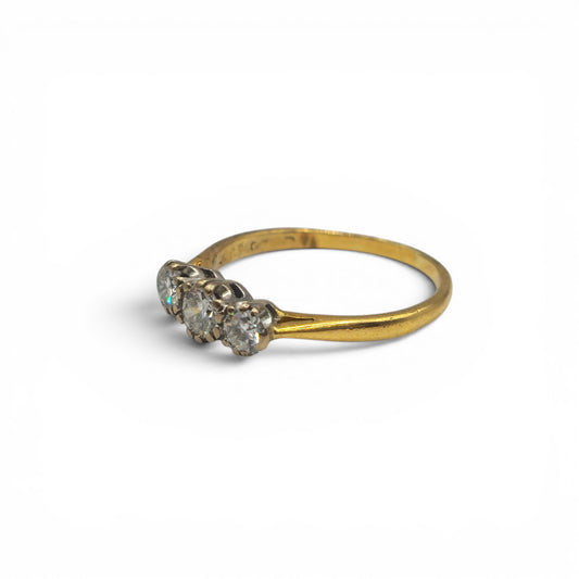 18ct yellow gold three-stone diamond ring by Reeves and Sons, showcasing sparkling diamonds set in a classic design.
