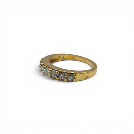 18ct yellow gold 7-stone diamond eternity ring by Reeves and Sons, showcasing sparkling diamonds on a sleek band.