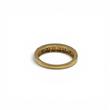 18ct yellow gold 7-stone eternity diamond ring by Reeves and Sons, showcasing sparkling diamonds set in a delicate band.