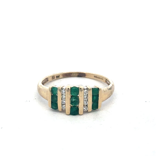 9ct yellow gold emerald and diamond ring by Reeves and Sons, showcasing a detailed design with vibrant green emerald and sparkling diamonds