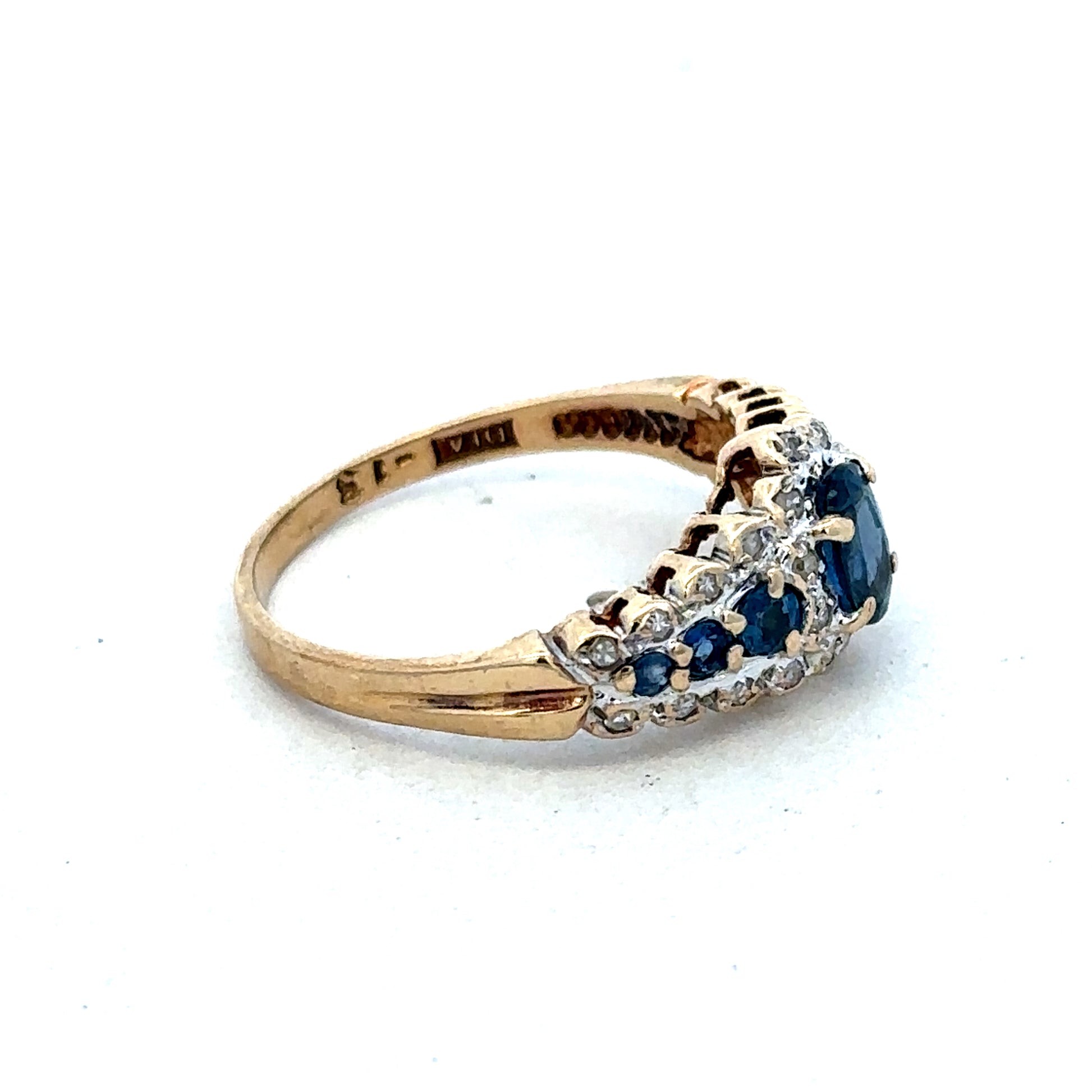 9ct yellow gold diamond ring by Reeves and Sons featuring a sparkling central diamond and intricate band design.