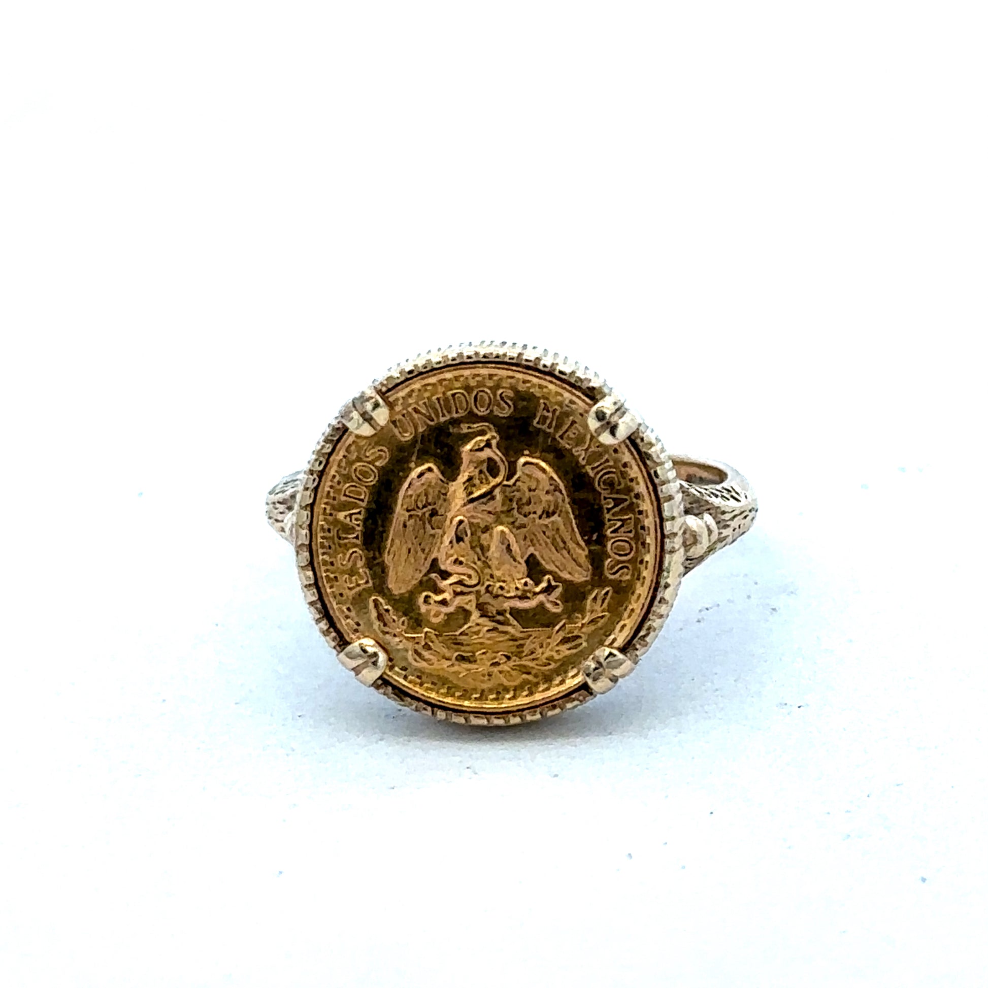 9ct gold Dos Pesos ring by Reeves and Sons, showcasing intricate design and craftsmanship in a close-up view.