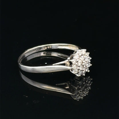 9ct white gold diamond cluster ring by Reeves and Sons, showcasing a sparkling diamond cluster design.
