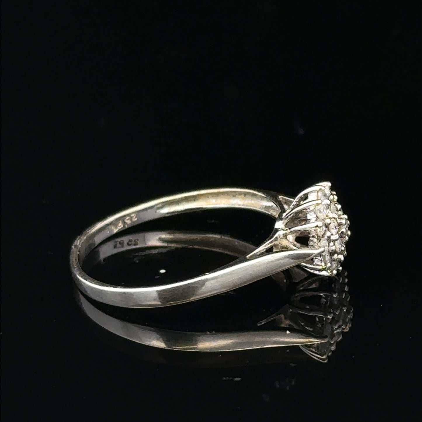 9ct white gold diamond cluster ring by Reeves and Sons, featuring a sparkling diamond cluster design on a sleek band.