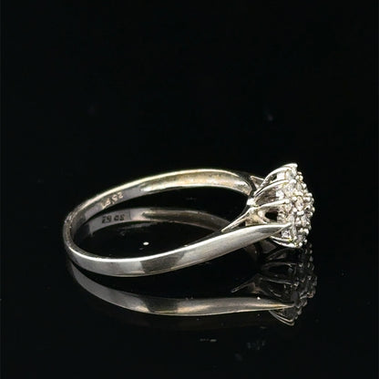 9ct white gold diamond cluster ring by Reeves and Sons, featuring a sparkling diamond cluster design on a sleek band.