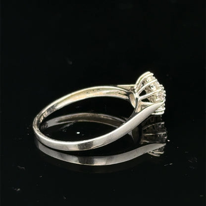 9ct white gold diamond cluster ring by Reeves and Sons, featuring a sparkling diamond cluster design.