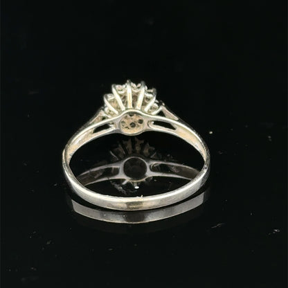 9ct white gold diamond cluster ring by Reeves and Sons, showcasing a sparkling diamond cluster design on a polished band.