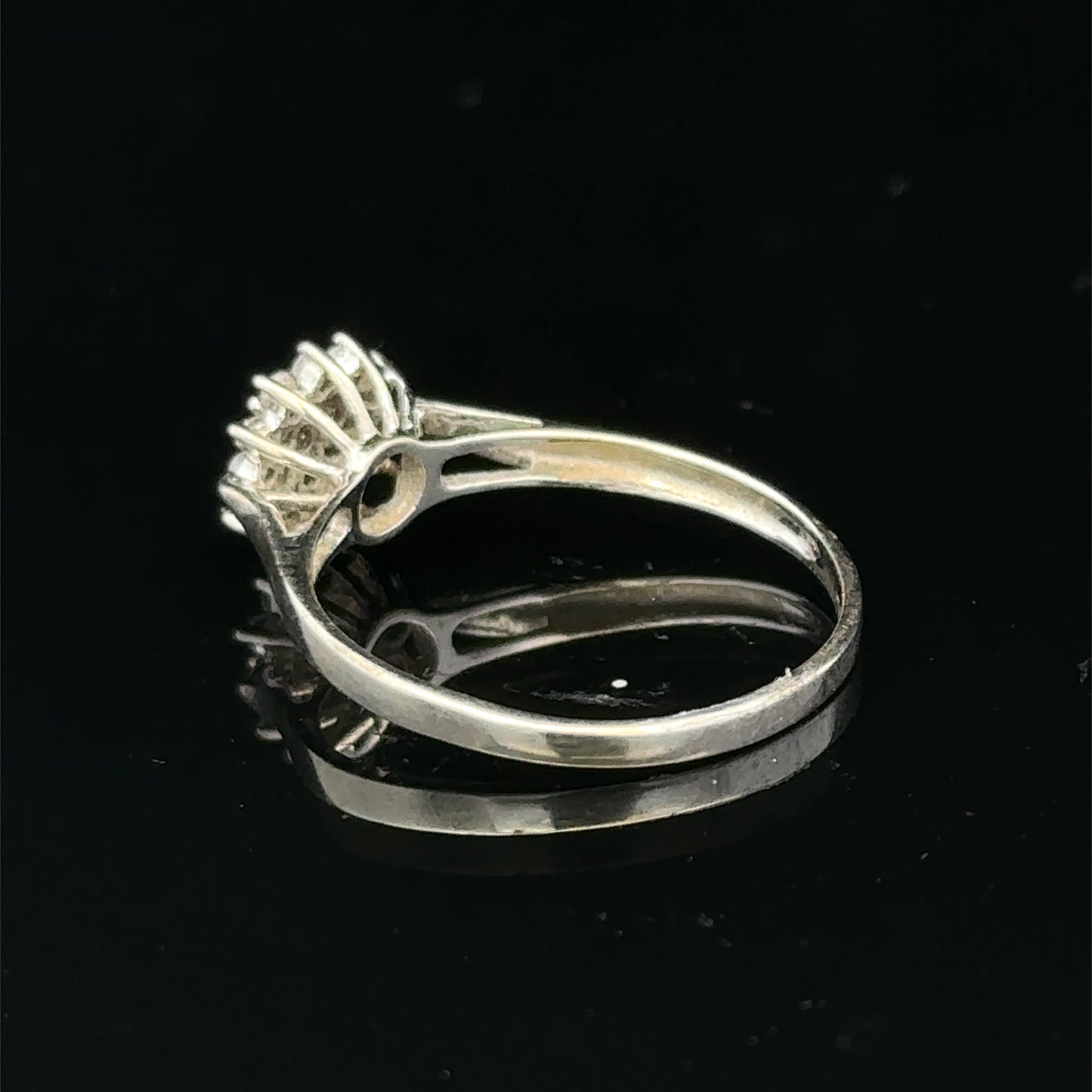 9ct white gold diamond cluster ring by Reeves and Sons, featuring sparkling diamond design and intricate craftsmanship.