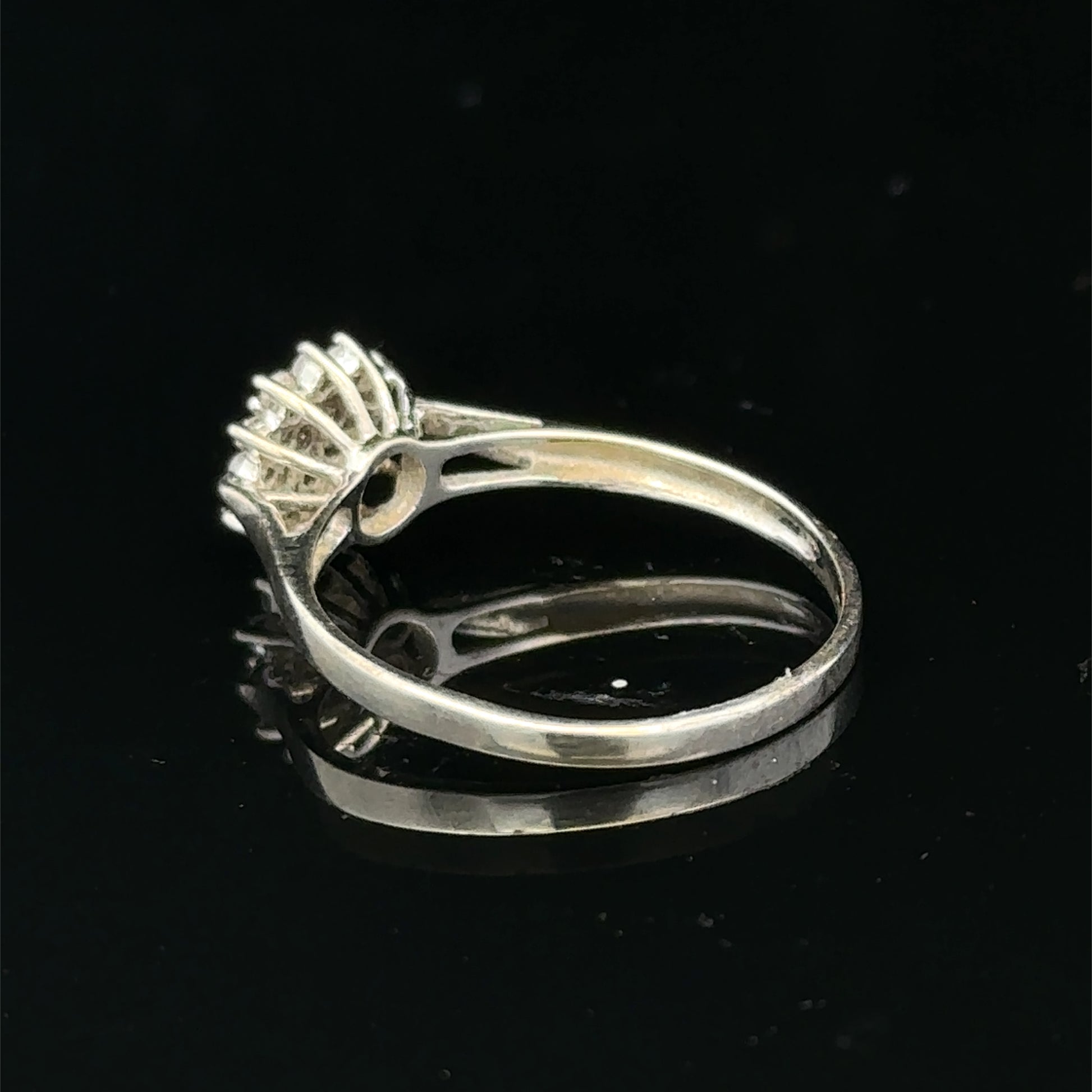 9ct white gold diamond cluster ring by Reeves and Sons, featuring sparkling diamond design and intricate craftsmanship.