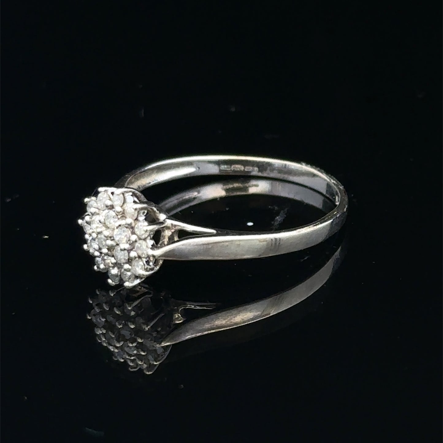 9ct white gold diamond cluster ring by Reeves and Sons featuring sparkling diamond accents and a elegant design.