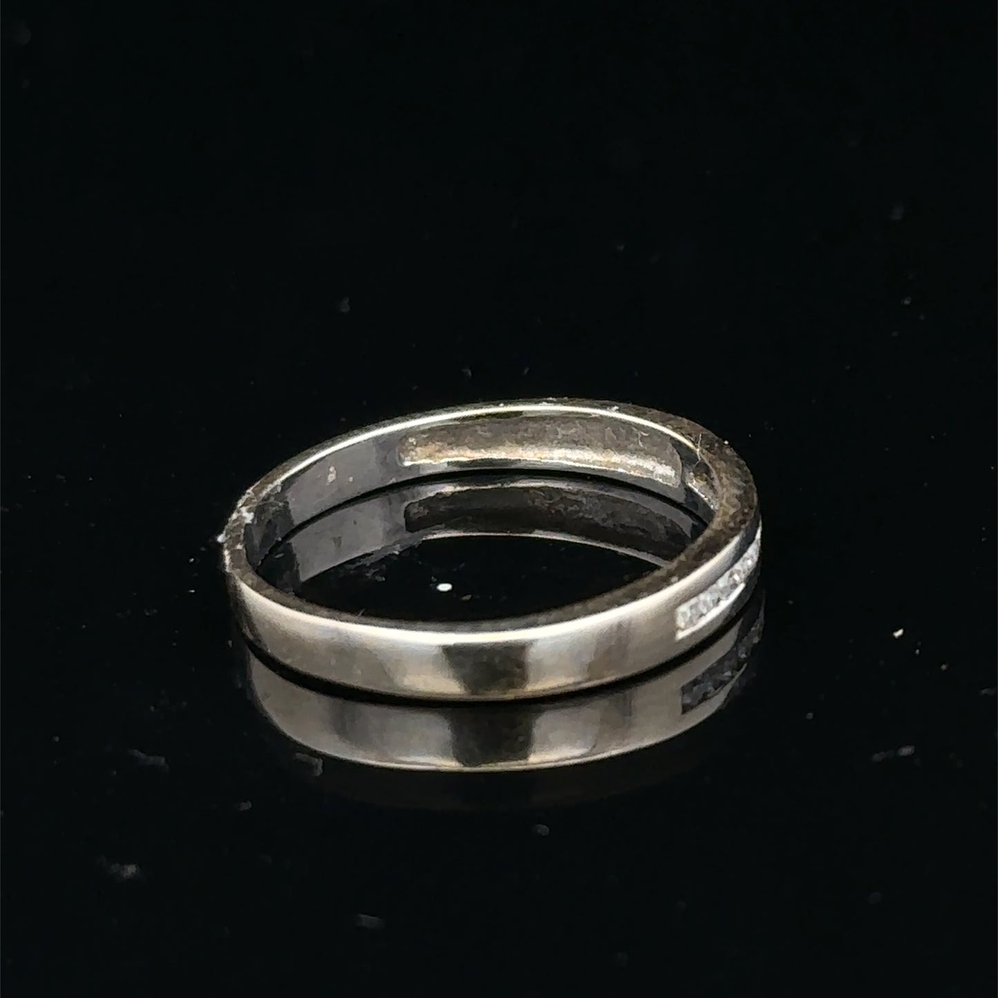 18ct white gold diamond half eternity ring with sparkling stones, showcasing Reeves and Sons' elegant jewelry design.