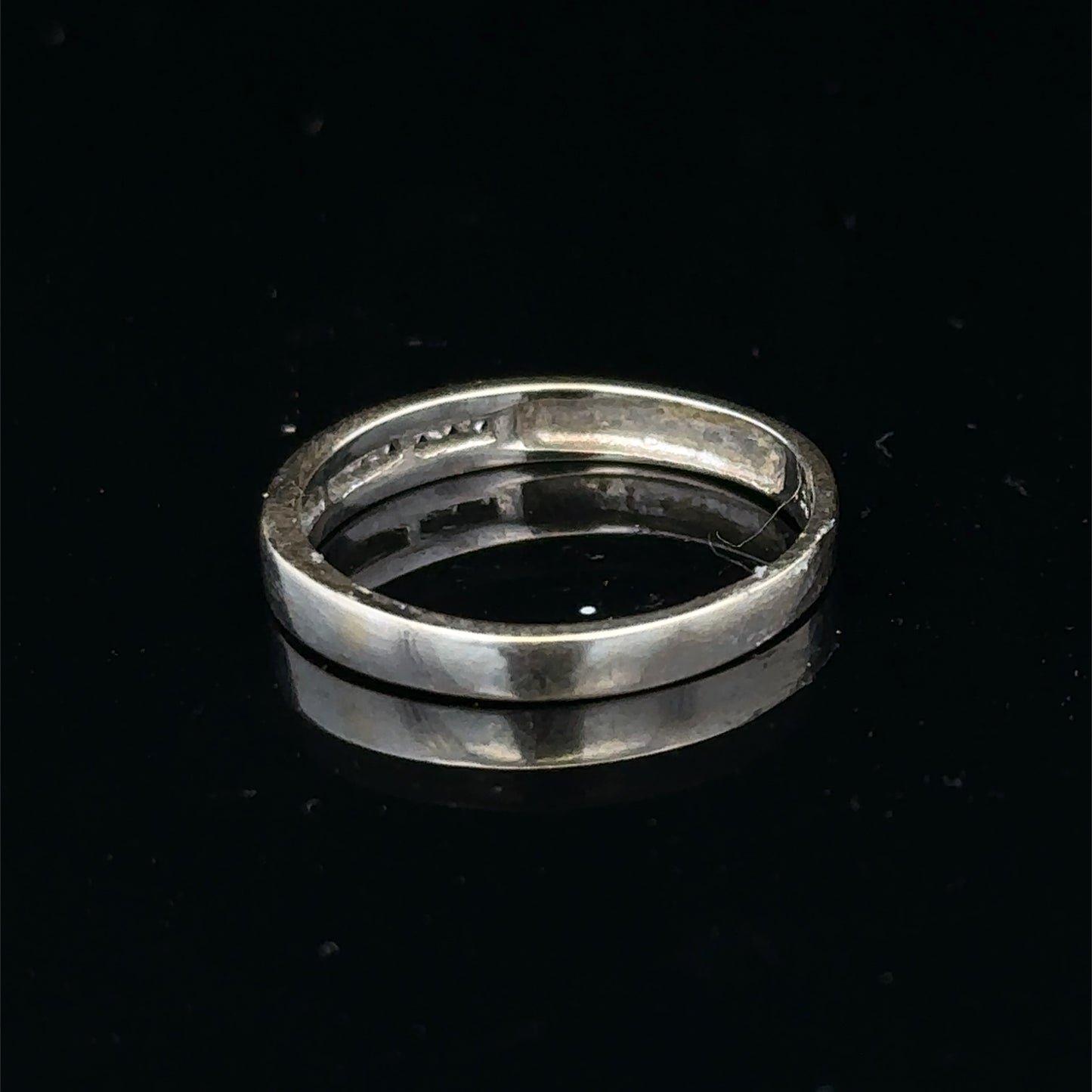 18ct white gold diamond half eternity ring with sparkling stones, crafted by Reeves and Sons, shown on a white background.