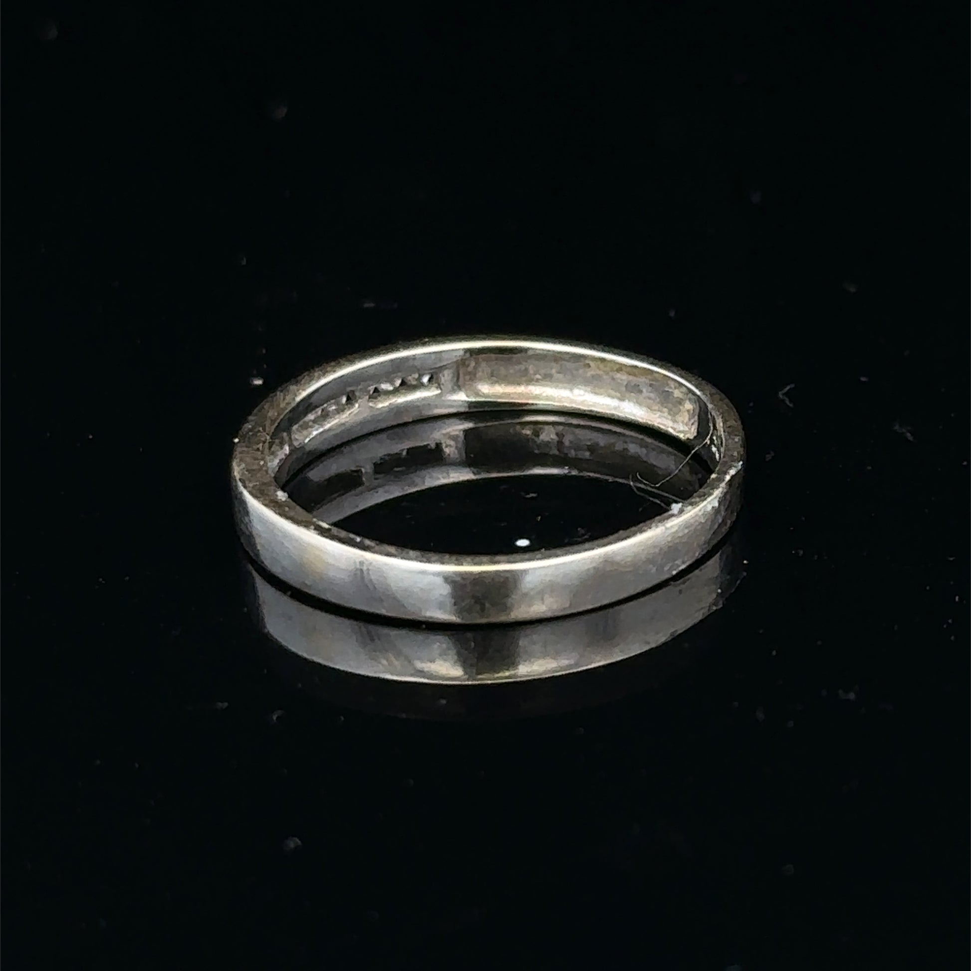 18ct white gold diamond half eternity ring with sparkling stones, crafted by Reeves and Sons, shown on a white background.