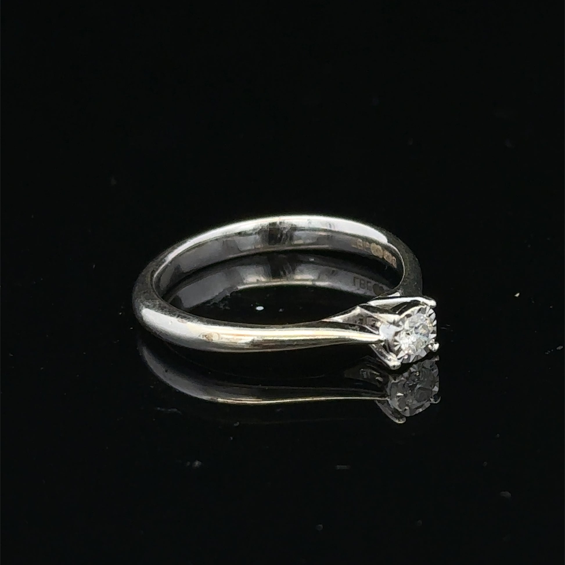 9ct white gold diamond solitaire ring by Reeves and Sons, featuring a sparkling central diamond on a sleek band.